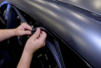 High angle view of man hand on car