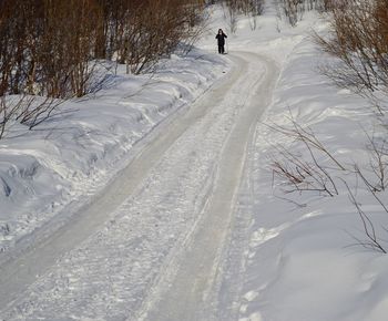 Tire tracks on snow covered landscape