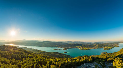 Scenic view of landscape and mountains against blue sky