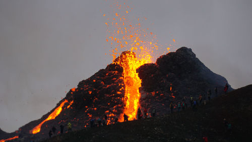 Bonfire against orange sky