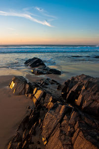 Scenic view of beach against sky during sunset