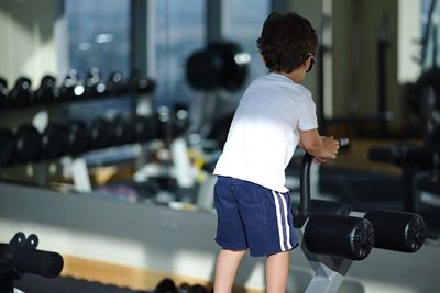 Rear view of child at gym