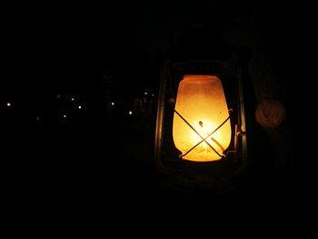 Close-up of lit lamp in dark room