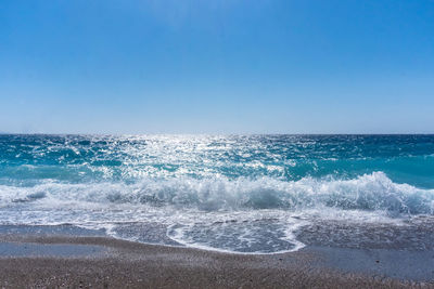 Scenic view of sea against clear blue sky