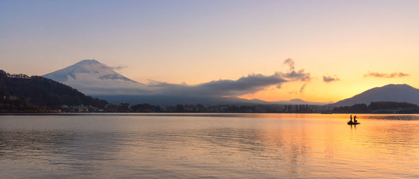 Scenic view of lake against sky during sunset