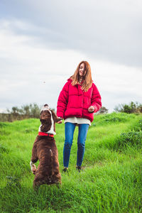 Woman with dog on grass