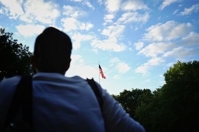 Rear view of man standing against sky