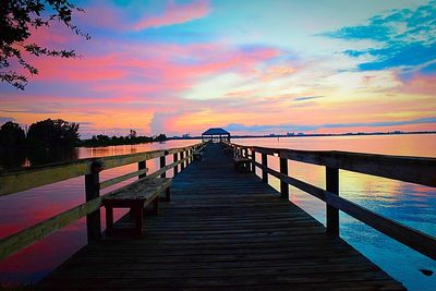 Pier on sea at sunset