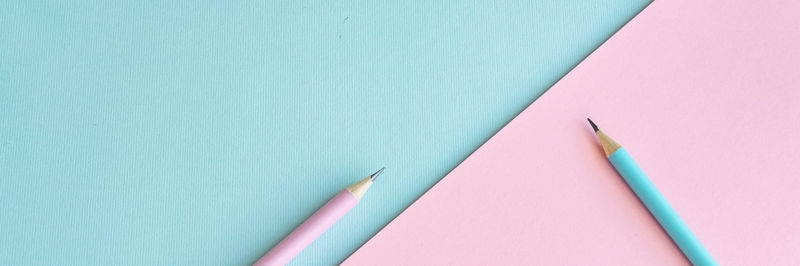 High angle view of colored pencils against blue background