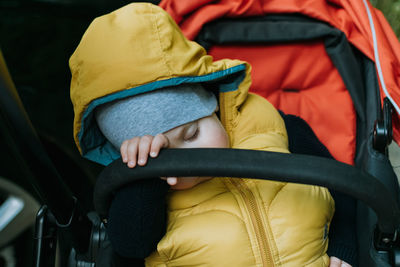 Midsection of baby sleeping in chairs