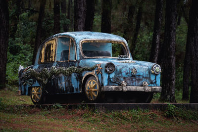 Abandoned car on field