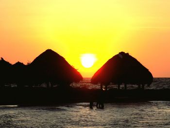 Scenic view of sea against orange sky