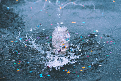 Water splashing in jar on street during rainy season