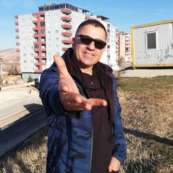 Portrait of man wearing sunglasses standing outdoors