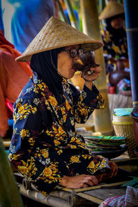 Midsection of woman holding umbrella