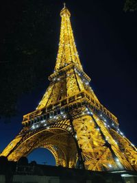 Low angle view of illuminated tower of building at night