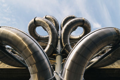 Low angle view of pipe against sky