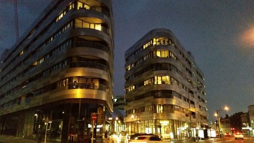 Low angle view of illuminated building against sky at night