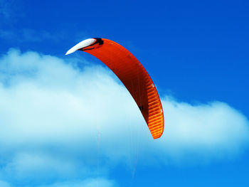 Low angle view of kite flying against blue sky