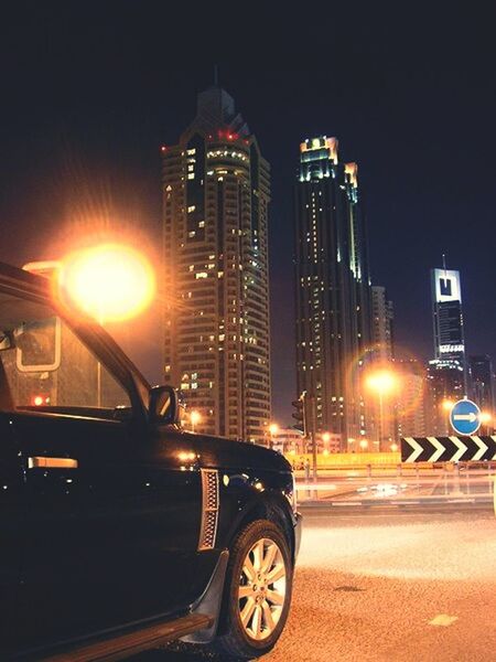 CAR ON ILLUMINATED ROAD AT NIGHT