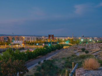 High angle view of illuminated buildings in city at night