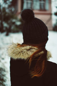 Rear view of woman wearing knit hat during winter