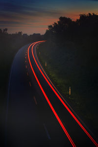 High angle view of light trails on road at night