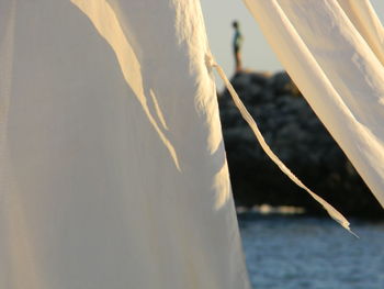 Close-up of sailboat in sea against sky