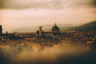 Cityscape against sky during sunset