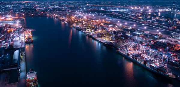 High angle view of illuminated buildings in city at night