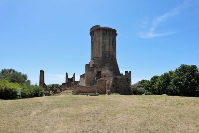 Castle on field against sky