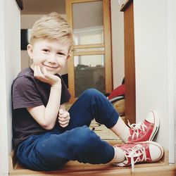 Portrait of boy sitting at home