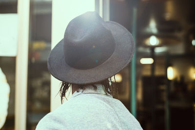 Rear view of man wearing hat in city