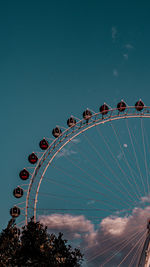 Low angle view of ferris wheel against sky