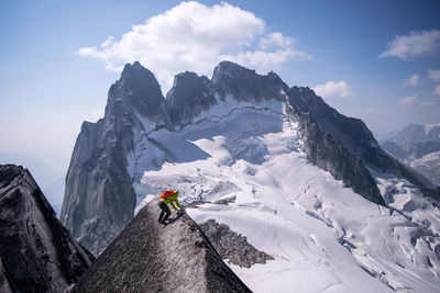 Young man climbing mountain during winter