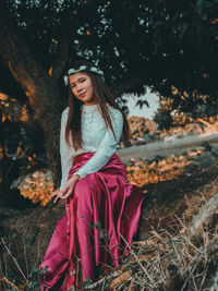 Full length of young woman wearing hat