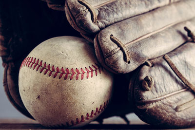 Close-up of baseball glove and ball on table