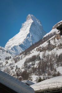 Scenic view of snowcapped mountains against clear sky