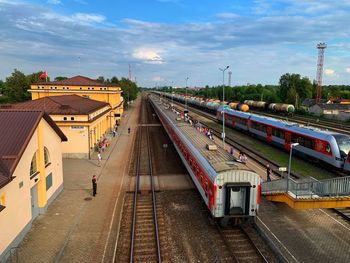 High angle view of train at railroad station in city against sky