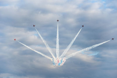 Low angle view of airshow against sky