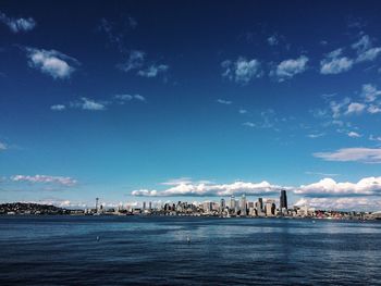 Distant view of city against sky seen from sea