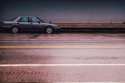 Car on street against sky