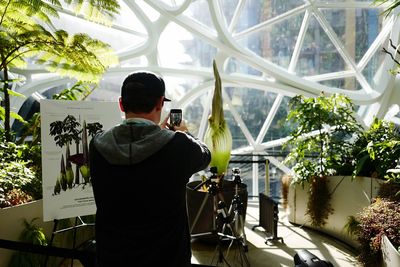 Rear view of man photographing