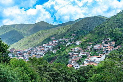 High angle view of townscape and mountains against sky