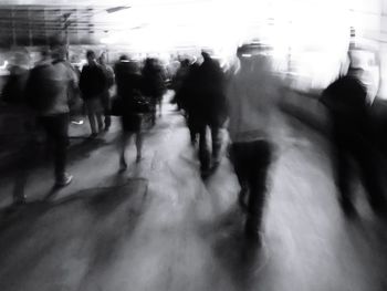 Blurred motion of people walking in city