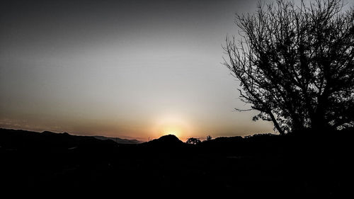 Scenic view of landscape against sky at sunset