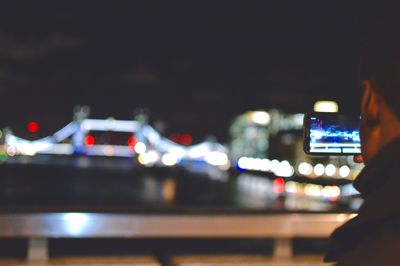 Man in illuminated city at night