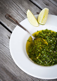 Green soup and lime on plate