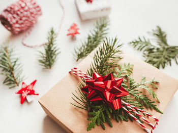 Christmas presents wrapped in craft paper with fir tree branches. decorations on new year gifts.