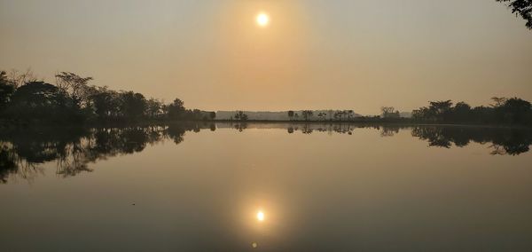 Scenic view of lake against sky during sunset